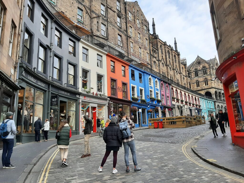 People walk along Victoria Street in Edinburgh, Scotland