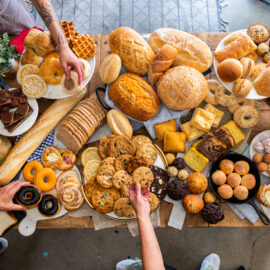 Table of food including breads and baked goods